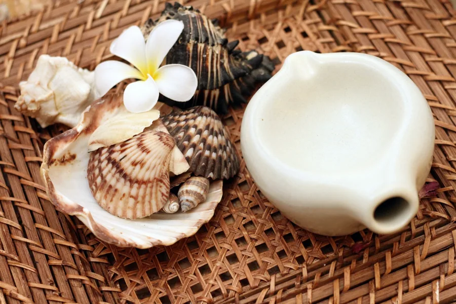 Shells, plumeria and a ceramic oil dish at Sea Spa